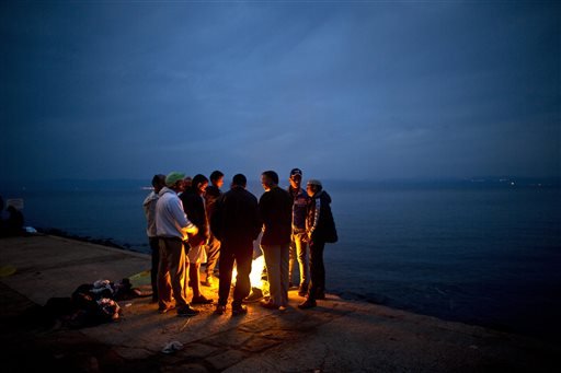 In this Tuesday, Oct. 6, 2015, file photo, Afghan refugees gather around a fire to warm themselves from the early morning cold, after spending the night at a resting point, after arriving on a dinghy from the Turkish coast to the northeastern Greek island of Lesbos. Afghans make up the second largest nationality -- after Syrians -- arriving on Europe’s shores, accounting for nearly a fifth of total arrivals, according to the U.N. Their flight is driven by despair in a country that remains mired in war and poverty despite a 14-year U.S.-led intervention and billions of dollars in international aid. And their ranks include middle and upper-class Afghans with skills needed to rebuild the war-torn country. (AP Photo/Muhammed Muheisen, File)